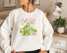 Delta Zeta Dee Zee DZ custom designed Gildan 18000 Sweatshirt.  Proudly display your Sorority around campus or at home with this comfy sweatshirt.  The collar is ribbed knit, so it retains its shape even after washing. There are no itchy side seams on these sweaters. Available in several colors (see drop down menu). 100% Greek Licensed through Affinity Licensing.  .: Made with a medium-heavy fabric blend of 50% cotton and 50% polyester ;  Heather Sport colors - 60% polyester, 40% cotton .: Made Delta Zeta Sweatshirt, Delta Zeta, Comfy Sweatshirt, Custom Sweatshirts, Heavy Fabric, Sorority, San Jose, Sweat Shirt, Favorite Outfit