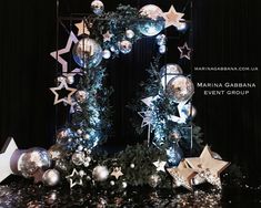 an image of christmas decorations on display in front of a black background with stars and snowflakes