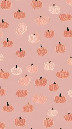 a pink background with orange pumpkins and black dots on the bottom half of it