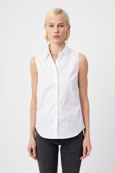 Our warm weather cotton staple. The Sleeveless Shirt is a classic for layering or to wear on its own. Narrow armholes mean bra won't peek through the side (and won't peek through the front either). Rochelle Behrens reimagined how shirts should fit and feel. Our patented No Gape® button technology, seamlessly designed into every shirt and shirtdress we design, eliminates blouse gape. Finally say bye bye blouse gape, hello The Shirt. 75% Cotton, 20% Nylon, 5% Stretch Made In Portugal Powered by ou Classic Sleeveless Tops For Everyday, Classic Cotton Vest Top, Classic Cotton Sleeveless Tank Top, Sleeveless Cotton Shirt For Daywear, Classic White Tank Top For Daywear, Classic Sleeveless Top For Daywear, Classic Summer Vest Tops, Classic Cotton Tank Top For Work, Everyday Cotton Vest Top