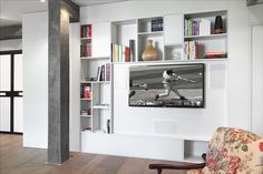 a living room filled with furniture and bookshelves