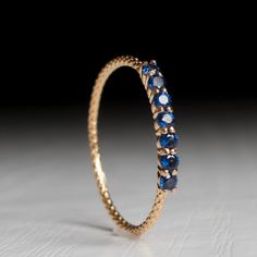 a gold ring with blue stones on it