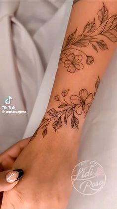 a woman's arm with flowers on it