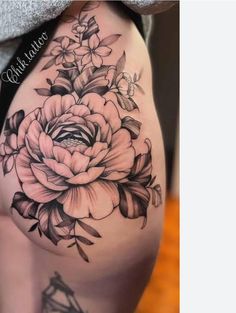 a woman's thigh with flowers on it