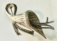 Rare ladies dazzling signed 1950's sphinx open lilly  styled silver plated brooch pre owned in excellent condition  with an open head attached to a bow like stem , highlighted with marcasite stones  from inside the head of the lilly a 4 fine free dangling silver chains to replicate the  stamen  with detail cuts inside the head fully working pin , has been steam cleand  very stylish art deco formed , a lovley gift  size.  6 x 3 cm  weight 10.5 grms Stylish Art, A 4, Brooch Pin, Silver Chain, Silver Plate, Silver Plated, Art Deco, Accessory Gift, Electronic Accessories