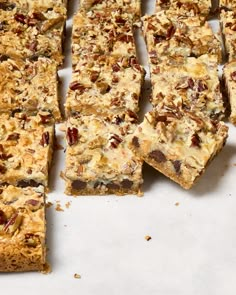 several pieces of food sitting on top of a white counter next to some nuts and raisins