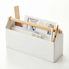 a pen and pencil holder filled with envelopes