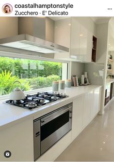 a kitchen with a stove top oven sitting next to a window and counter tops in front of it