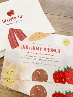 two birthday cards are sitting next to each other on a wooden table with strawberries and cookies