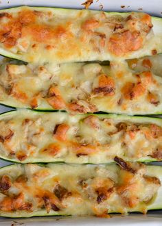 zucchini stuffed with meat and cheese in a white dish