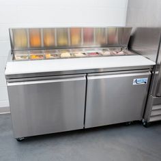 a stainless steel refrigeration unit with ice cream on the front and sides