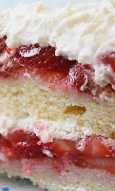 a piece of strawberry shortcake on a plate with a fork next to the cake