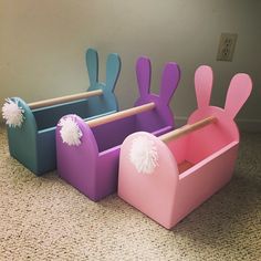 three toy bins with bunny ears and pom poms on them