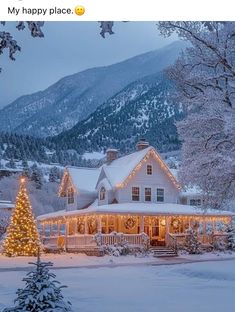 a large white house with christmas lights on it's roof and trees in the front yard