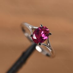 It is a ruby ring. The main stone is 6mm*8mm oval cut, weight about 1.75 carats. The basic metal is sterling silver and plated with rhodium. To change the metal to a solid gold (white/rose) or platinum is also available, please ask for a quotation if you want. You can also go to my shop Home for more elegant rings: https://www.etsy.com/shop/godjewelry?ref=hdr_shop_menu More rings: https://www.etsy.com/shop/godjewelry?ref=l2-shop-header-avatar Customization is always welcome and please feel free Oval Ruby Ring With Prong Setting In Sterling Silver, Oval Sterling Silver Ruby Promise Ring, Modern Silver Ruby Ring With Oval Shape, Oval Ruby Ring In White Gold Sterling Silver, Fine Jewelry Oval Sterling Silver Ruby Ring, Minimalist Oval Ruby Ring For Anniversary, Exclusive Engagement Rings, Elegant Rings, July Birthstone Ring