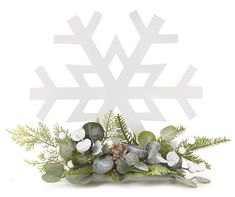 a white snowflake with green leaves and flowers in front of a white background