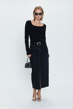 Of-the-moment, yet eternally stylish - our best selling skirt features an elongated midi length and five pocket denim design notes. Crafted from rigid denim without stretch for sophisticated fit and fall, with a well considered front skirt slit for¬†ease of movement. Offered in a dark black wash with frayed hem detail. 100% Cotton Imported Long Black Denim Skirt Outfits, Black Denim Midi Skirt Outfit, Long Black Denim Skirt Outfit, Black Leather Midi Skirt, Black Denim Skirt Outfit, Black Denim Midi Skirt, Black Vacation, Street Style Skirt, Holy Girl