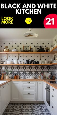 a kitchen with white cabinets and black and white tiles on the wall, next to an open shelving unit