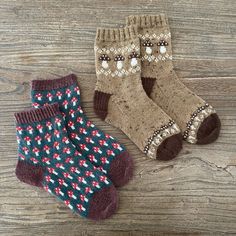 two pairs of socks sitting on top of a wooden floor