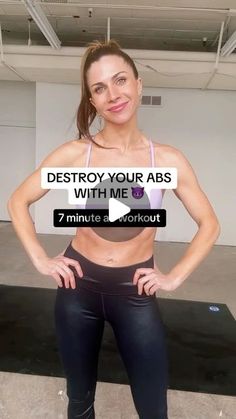 a woman posing for the camera in a gym outfit with her hands on her hips