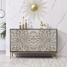 a white and gold sideboard with an artistic design on the front in a living room