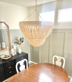 a chandelier hanging from the ceiling in a dining room