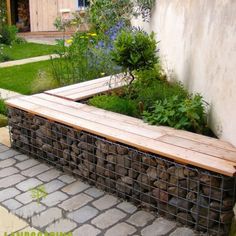 a wooden bench sitting in the middle of a garden