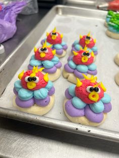 there are many decorated cookies in the shape of birds on top of doughnuts