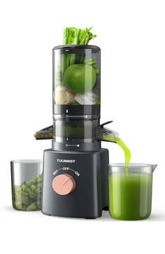 a blender filled with lots of vegetables and juices next to two cups full of green smoothies