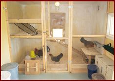 the inside of a chicken coop with chickens in it