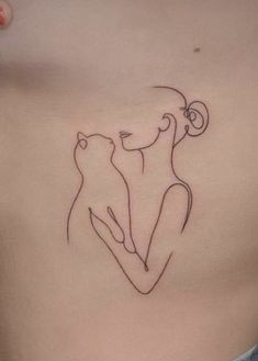 a woman's stomach with a cat tattoo on her chest and the outline of a dog