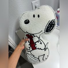 someone is holding up a stuffed snoopy bear