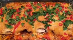 a casserole dish with meat, cheese and vegetables in it on a stove top