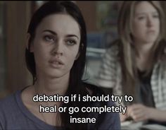 two women sitting at a table in front of a computer screen with the caption saying, debate if i should try to heal or go completely insane