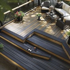 a deck with chairs, table and couches on it