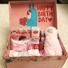 a pink box filled with personal care items on top of a white carpeted floor