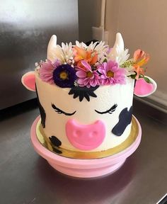 a cake decorated with flowers and a cow face