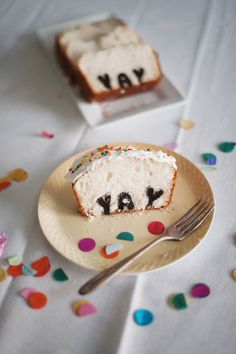 a piece of cake on a plate with the word ya written on it next to a fork and confetti