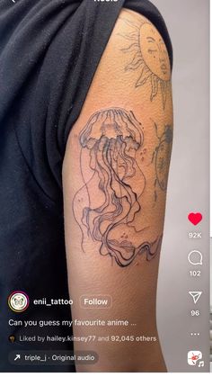 a person with a tattoo on their arm and an image of a jellyfish in the background