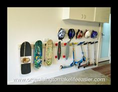 several skateboards and scooters are hanging on the wall next to each other