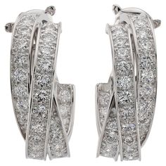 These fabulous and rare inside-out oval wrap earrings from Cartier's iconic Trinity collection are crafted 18k white gold and set with brilliant-cut D-E-F VVS1-VVS2 diamonds. This is the a large model of these flattering earrings. Made in France circa 2000s. Measurements: 0.35" (9mm) width, 1.14" (29mm) length. Excellent condition. Comes with original pouch and Cartier service paperwork. Flattering Earrings, Vintage Cartier Watch, Earring Video, Cartier Diamond, Cartier Earrings, Wrap Earrings, Small Bracelets, Bangles Making, White Gold Earrings