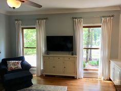 the living room is clean and ready to be used for tvs, movies, and more