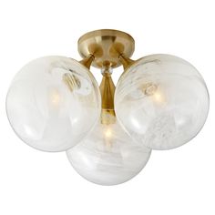 three clear glass globes are mounted on the ceiling fixture in this modern flush mount