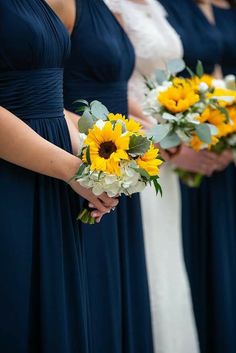 the bridesmaids are holding sunflowers and bouquets