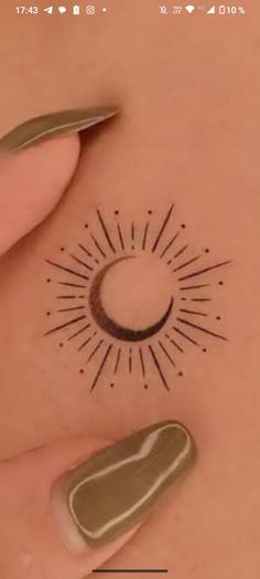 a woman's stomach with a small sun tattoo on her belly and an arrow in the middle