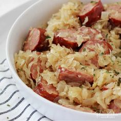 a white bowl filled with sausage and sauerkraut