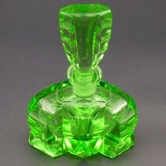 a green glass object sitting on top of a table