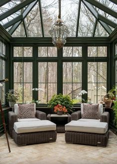 a sun room with two chairs and a table