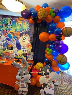 a table with balloons and decorations for a baby's basketball birthday party at disney world