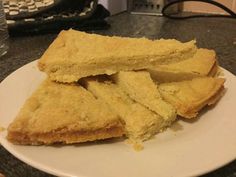 some food on a white plate sitting on a counter top next to a computer keyboard